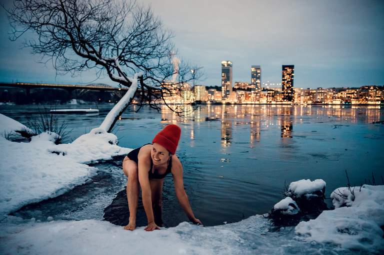 A woman on her way to taking a winter bath late afternoon in Stockholm, Södermalm