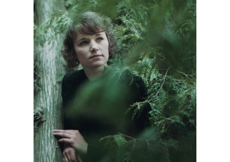 Iiris Viljanen i ett skogslandskap.