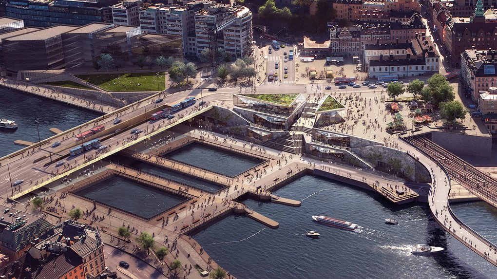 Bild ur fågelperspektiv över Slussenområdet, med olika broar över vattnet som leder till Gamla Stan.